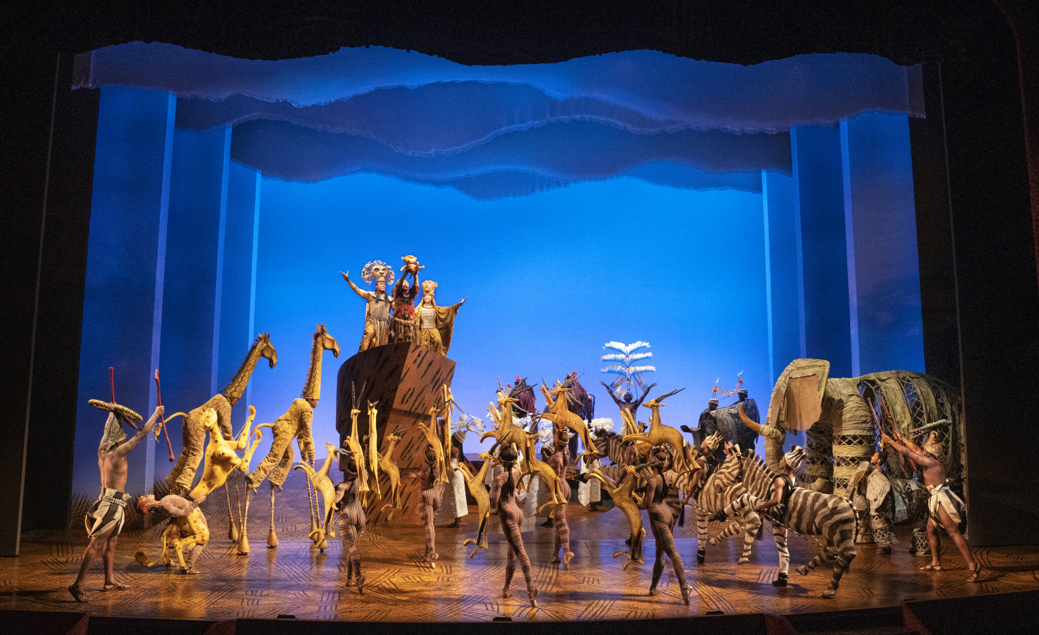 Company of The Lion King on Broadway in the Circle of Life opening number, full stage view
