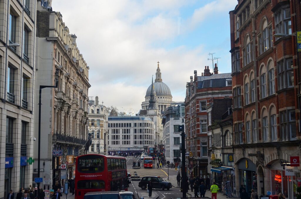 Fleet Street in London with a red double-decker bus and the dome of St Paul's Cathedral in the distance