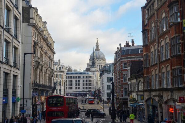Fleet Street in London with a red double-decker bus and the dome of St Paul's Cathedral in the distance