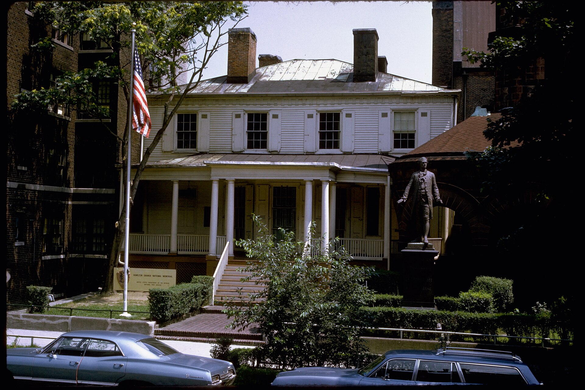 The yellow Federal-style Hamilton Grange house in Upper Manhattan, surrounded by trees