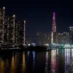 Ho Chi Minh City skyline with Landmark 81 lit up at night and reflected in the Saigon River