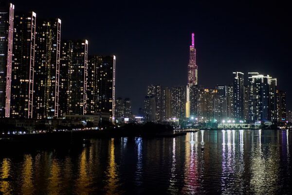 Ho Chi Minh City skyline with Landmark 81 lit up at night and reflected in the Saigon River