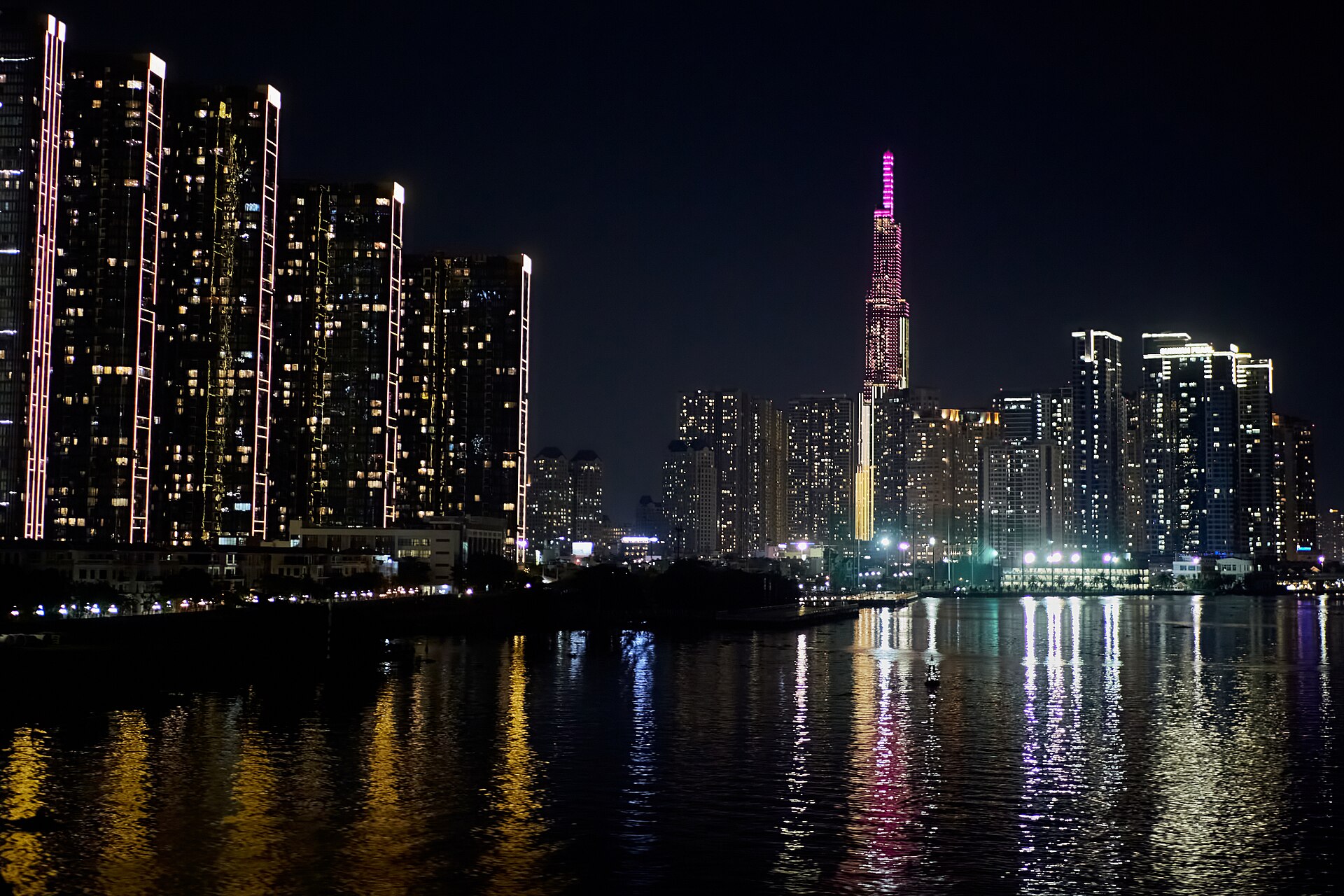 Ho Chi Minh City skyline with Landmark 81 lit up at night and reflected in the Saigon River