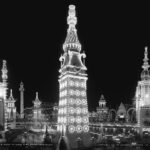 Black-and-white photograph of Luna Park at Coney Island around 1905, its towers outlined in electric lights at night