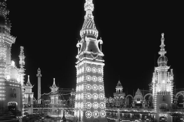 Black-and-white photograph of Luna Park at Coney Island around 1905, its towers outlined in electric lights at night