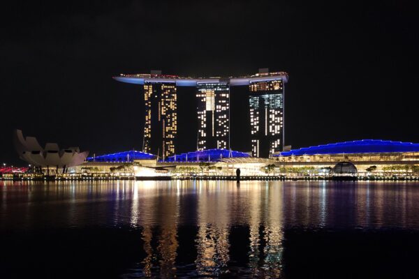 Marina Bay Sands in Singapore lit up at night across the water, home of the Sands Theatre where touring musicals play