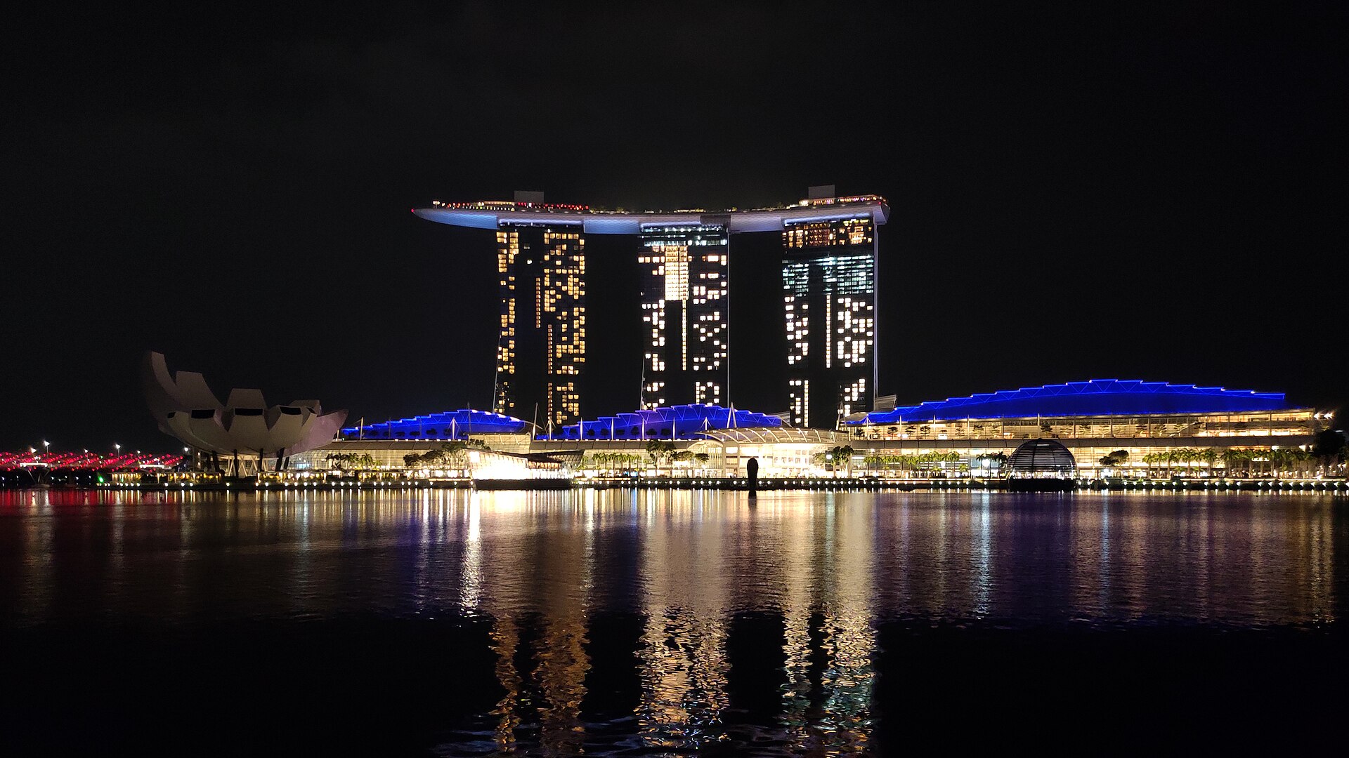 Marina Bay Sands in Singapore lit up at night across the water, home of the Sands Theatre where touring musicals play