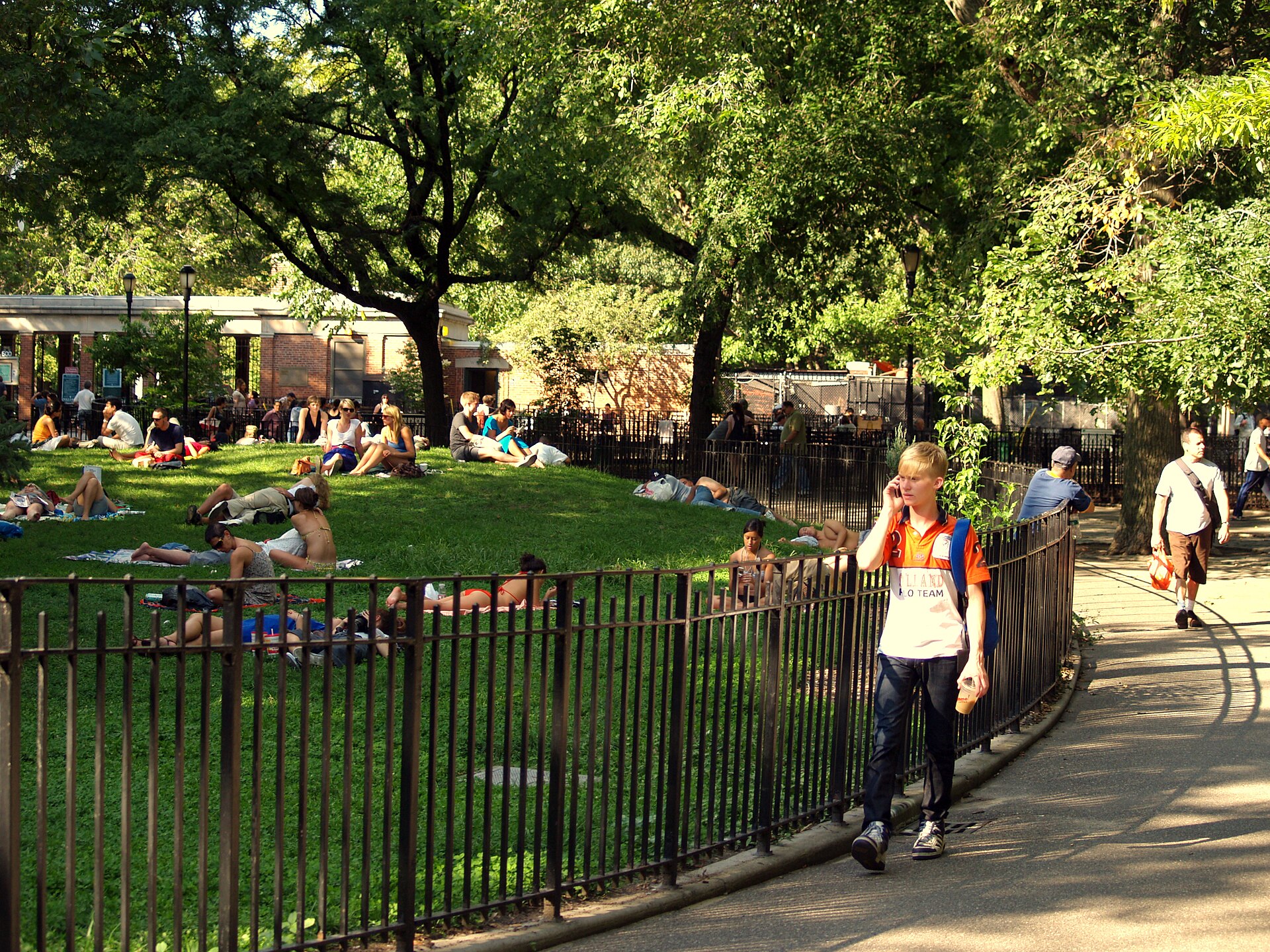 People relaxing on the lawn of Tompkins Square Park in New York's East Village