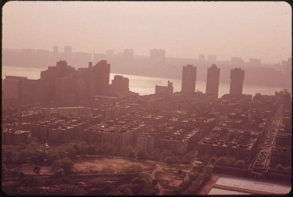Hazy view over Upper Manhattan apartment buildings toward the Hudson River and the New Jersey shore