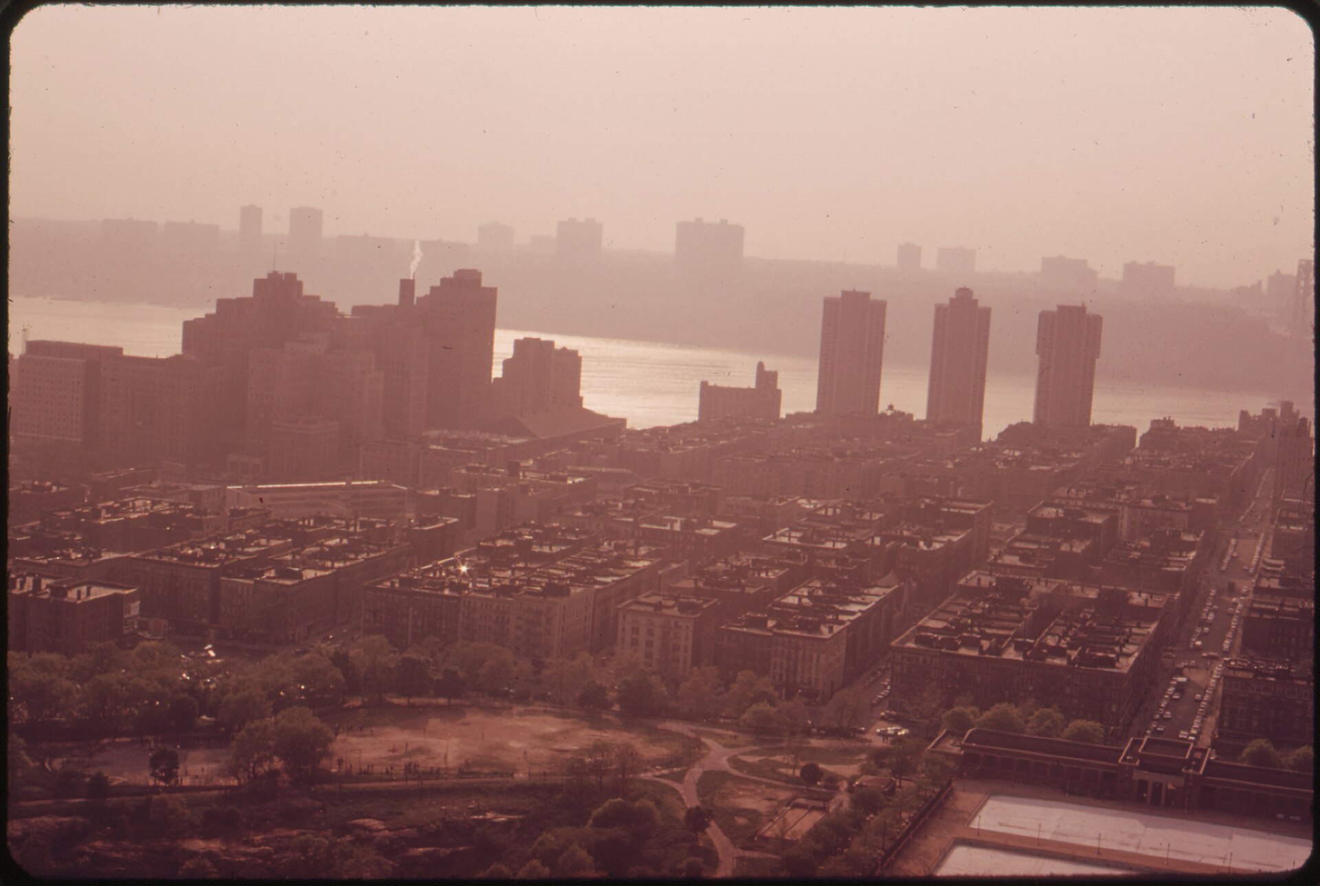 Hazy view over Upper Manhattan apartment buildings toward the Hudson River and the New Jersey shore