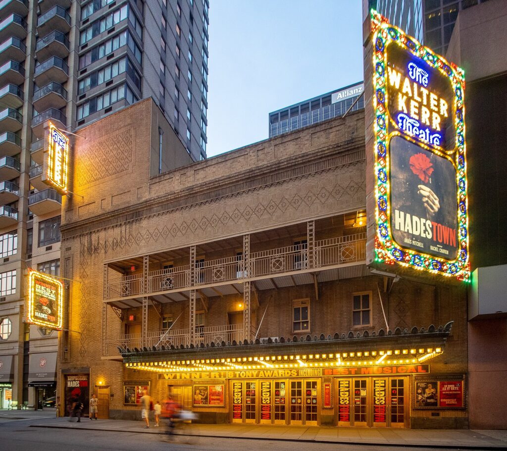 The Walter Kerr Theatre on Broadway with its illuminated Hadestown marquee at dusk