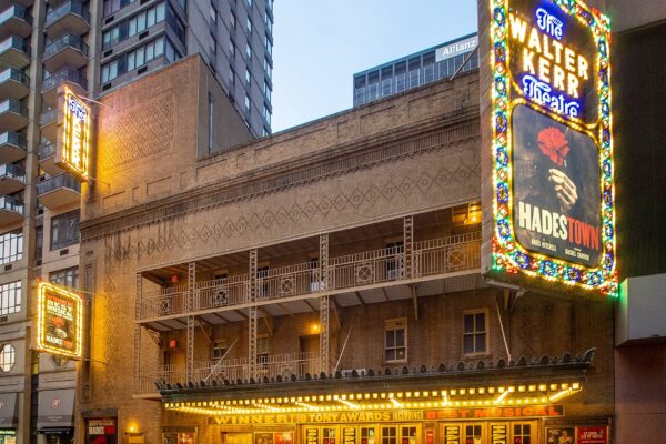The Walter Kerr Theatre on Broadway with its illuminated Hadestown marquee at dusk
